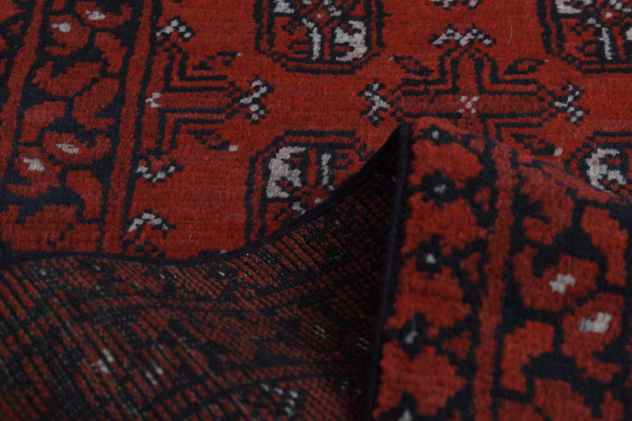 A red Turkmen-style carpet from Aqcha, Balkh province, with gul medallion patterns