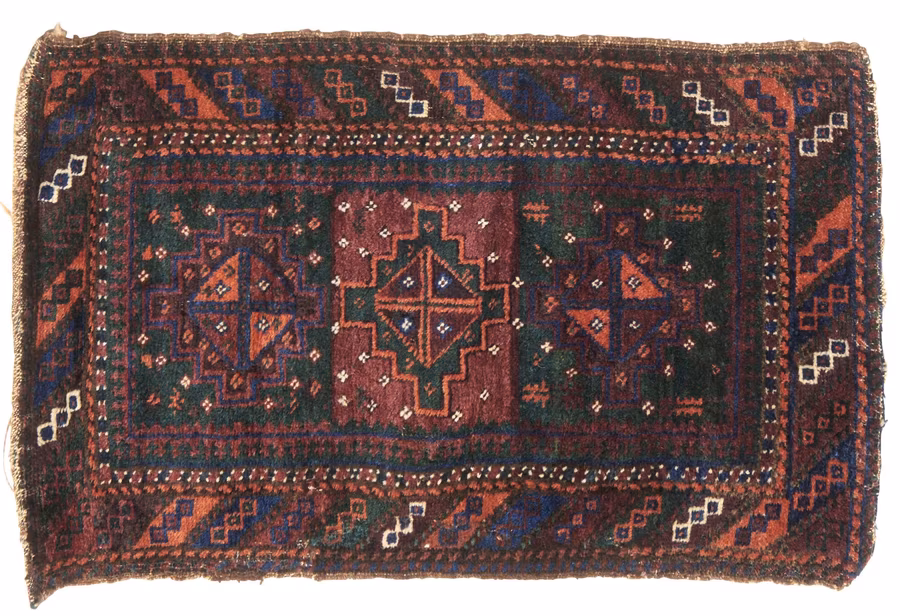 A Baluch balisht with a deep red and navy diamond medallion pattern, late 19th century
