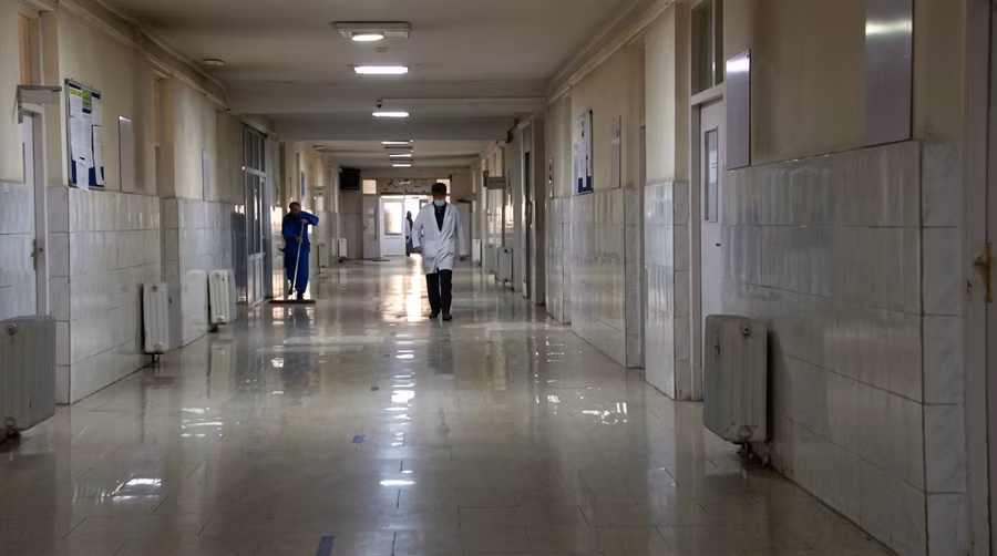 A doctor walking through a corridor at Ali Abad Hospital in Kabul