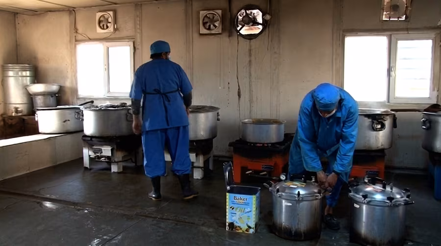Kitchen staff preparing meals at Ali Abad Hospital in Kabul