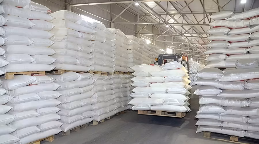 A warehouse stacked with pallets of imported flour sacks